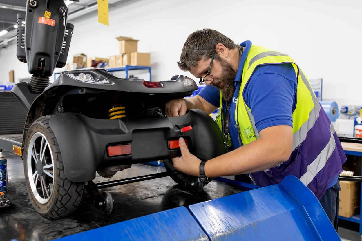 Colleague assembling a mobility scooter at CareCo HQ